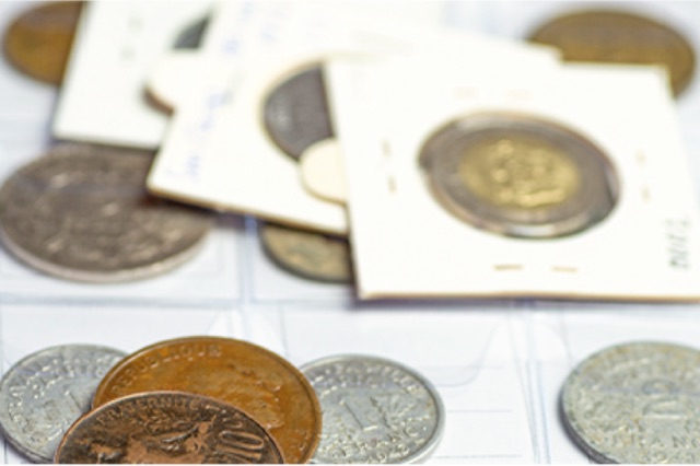 A coin collection in card holders and album sleeves