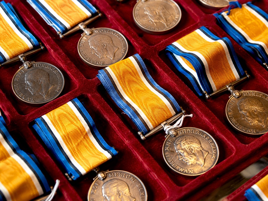 First World War service medals with ribbons, laid in a red velvet collectors&rsquo; tray
